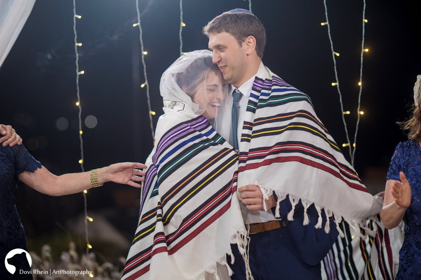 הזוג עטוף בטלית מתחת לחופה